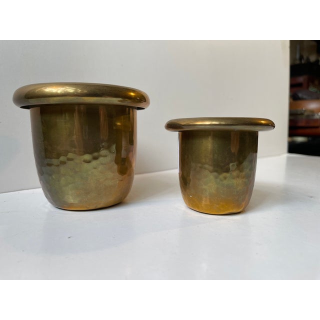 A set of small planters in hammered brass featuring folded edges. Both stamped by an unknown Swedish maker circa 1920-50....