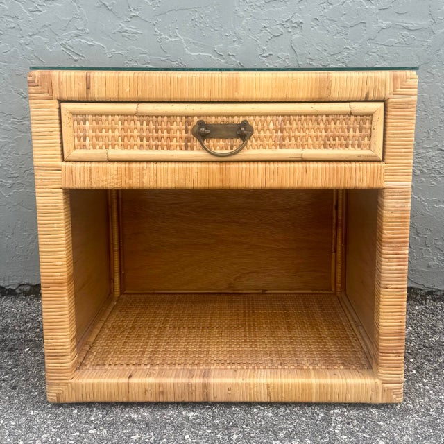 A charming boho chic nightstand that beautifully captures relaxed coastal sophistication through its expertly wrapped...