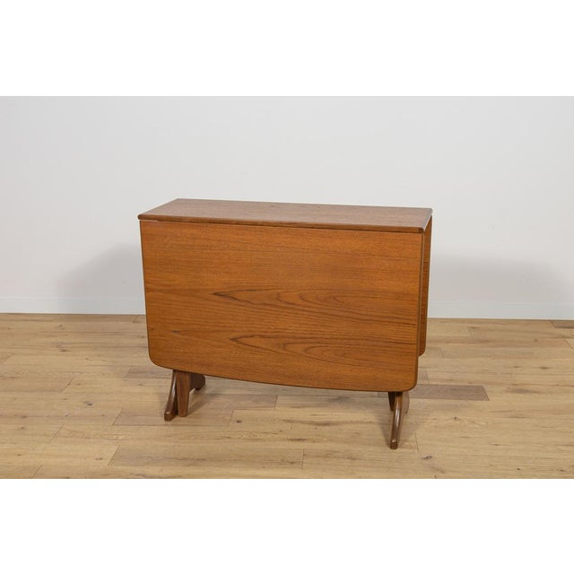 This dining table in teak dates from the 1960s. The table manufactured by G-Plan in United Knigdom. The teak elements have...