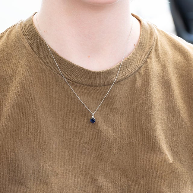 Minimalist elegance meets timeless brilliance in this pendant featuring a vivid blue sapphire accented with a sparkling...