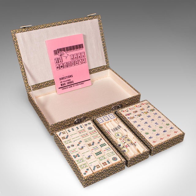 This is a vintage Mah Jong case. A Chinese, upholstered gaming box with bamboo pieces, dating to the mid 20th century,...
