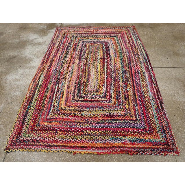 A vintage American Braided accent rug handmade during the mid-20th century. Measures: 5' 3" x 8' 1"