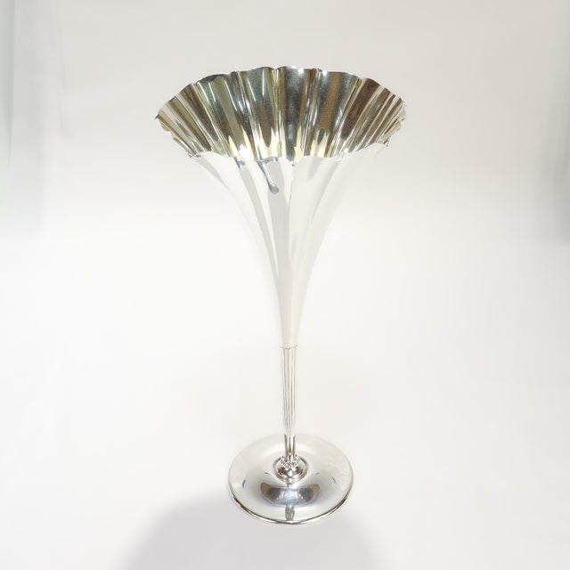 A fine signed, antique trumpet form flower vase. By Tiffany & Co. In sterling silver with a lightly gilt interior With a...