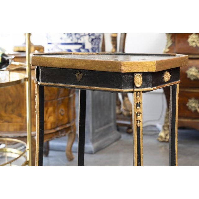 An elegant English Chinoiserie ebonized side table, combining refined craftsmanship with timeless Asian-inspired...