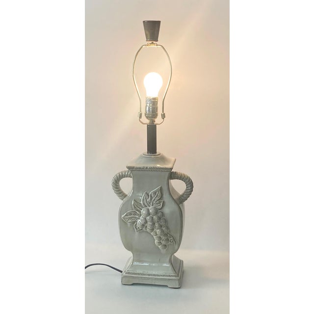 Glazed ceramic antique white urn style lamp. Shows white glaze over caramel undertones on the body and caramel over white...