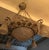This French Art deco Chandelier has grapes and leafs motif surrounding the outer bowl on the metal work, with four tulips...