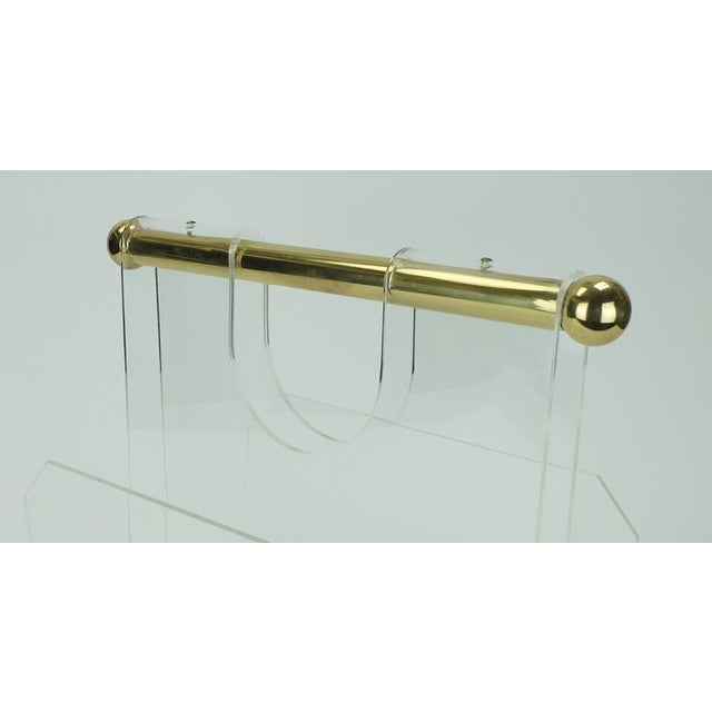 Magazine rack with 2 compartments, made of acrylic with a thick round brass handle. Dimensions in cm: Width 40 cm (incl....