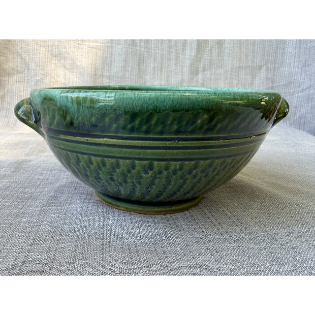 Vintage small green hand thrown glazed pottery bowl with small side handles. No marks. Bowl measures 6 3/4" by 5 3/4" by...