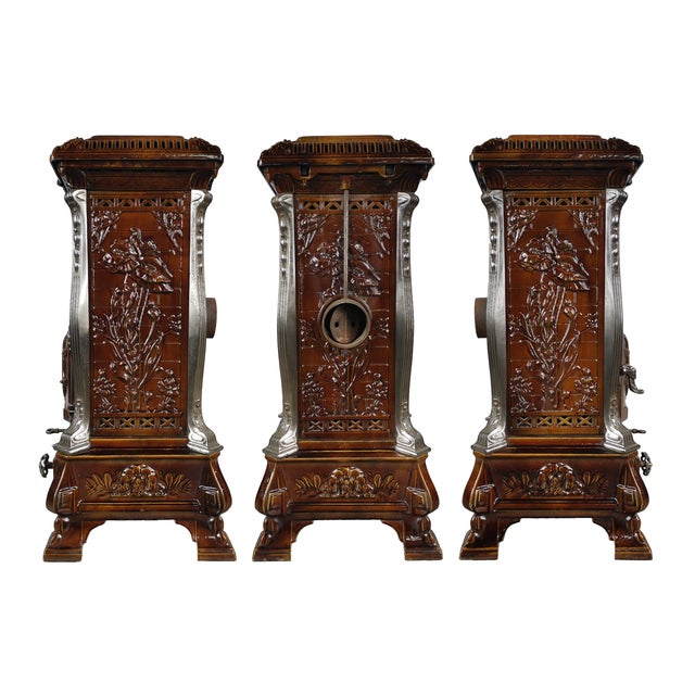 A vintage original French cast iron stove with a brown enamel finish. Richly decorated in Art Nouveau style, it features...