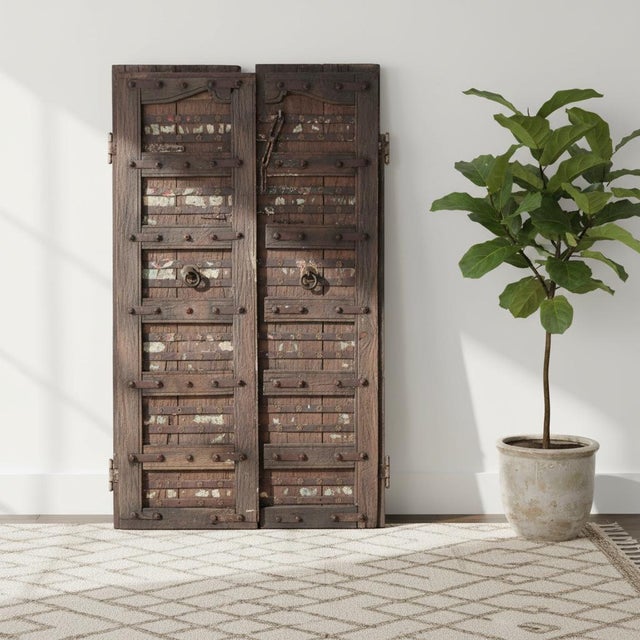 Dimensions: 38"wide X 69"high This is an antique teak wood door from India. It wears its naturally distressed colored...
