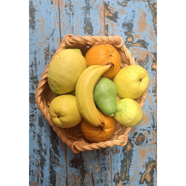 A highly realistic fruit bowl, with fruit integrated into a woven basket. A classic of Valencian decorative craftsmanship...