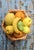 A highly realistic fruit bowl, with fruit integrated into a woven basket. A classic of Valencian decorative craftsmanship...