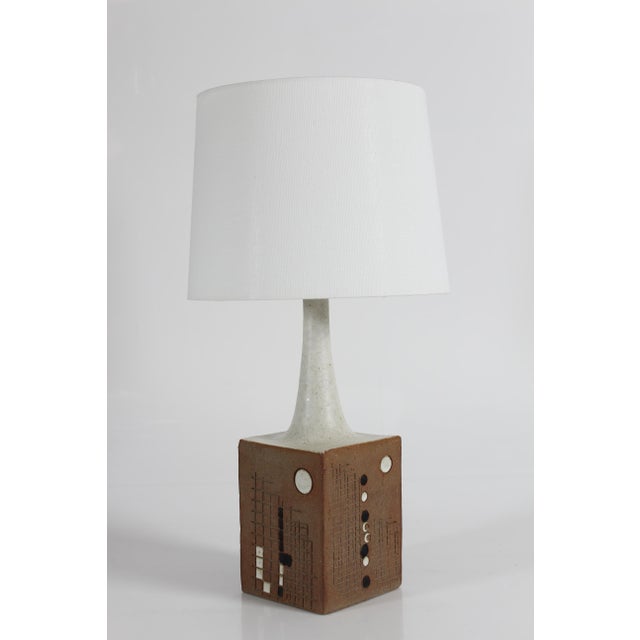 Mid-century Danish ceramic table lamp by Hans Still for the ceramic workshop Axella. Made circa 1970s. The lamp base is...