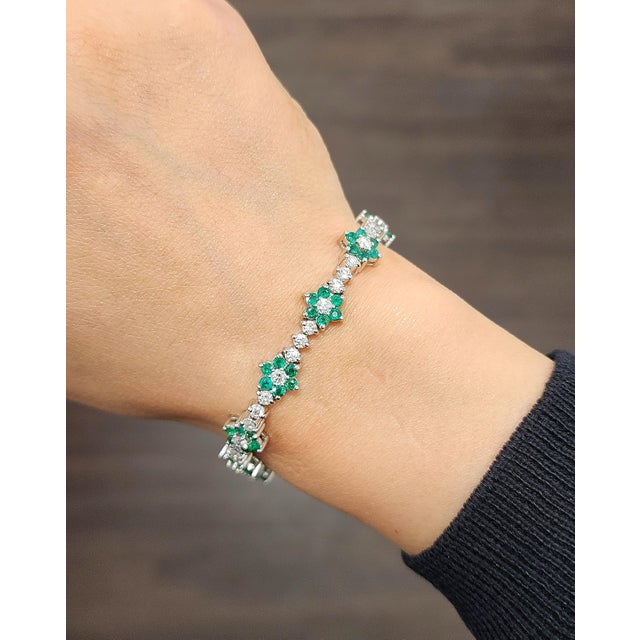 This elegant tennis bracelet exemplifies modern design and fine craftsmanship. Featuring 3.85 carats of natural round-cut...