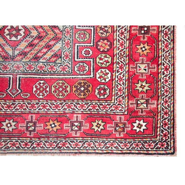 A playful early 20th century Anatolian Turkish rug with three large geometric medallion living amidst a field of stylized...
