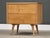 A mid century modern solid maple two drawer nightstand with polished brass hourglass knobs and canted legs designed by...