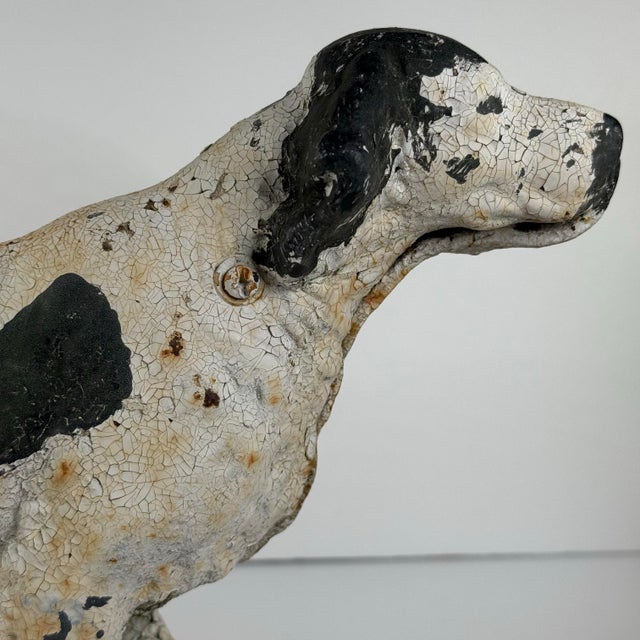 A wonderfully weathered early 20th-century cast iron English Setter sculpture in classic “on point” field posture....