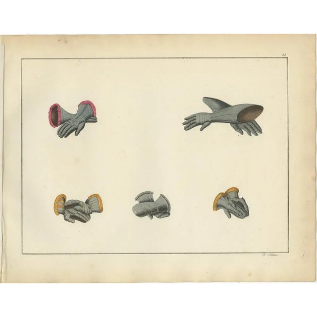 19th-Century Hand-Coloured Lithograph of Medieval Gauntlets and Arm Defenses This finely detailed hand-coloured lithograph...