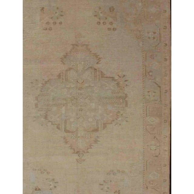 Measures: 6'4 x 9'. Vintage Turkish Oushak Rug with Faded Sand Field and Pale Brown Medallion. Keivan Woven Arts / rug...