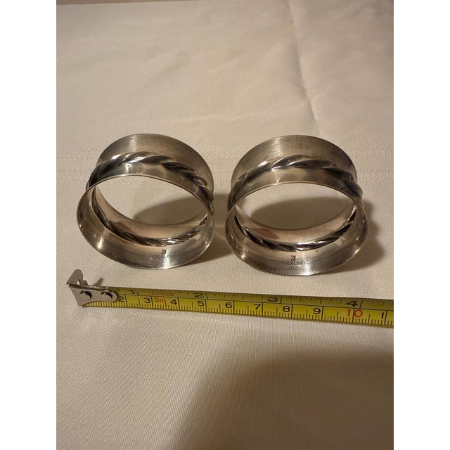 Elevate your tablescape with this handsome pair of vintage mid-century sterling silver napkin rings. Featuring a timeless,...