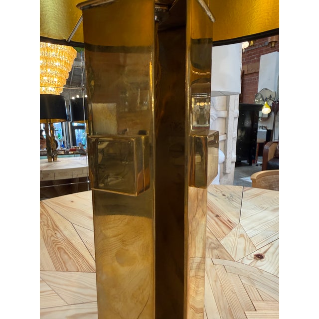 Striking pair of sculptural brass table lamps featuring bold geometric forms and an architectural modernist silhouette....