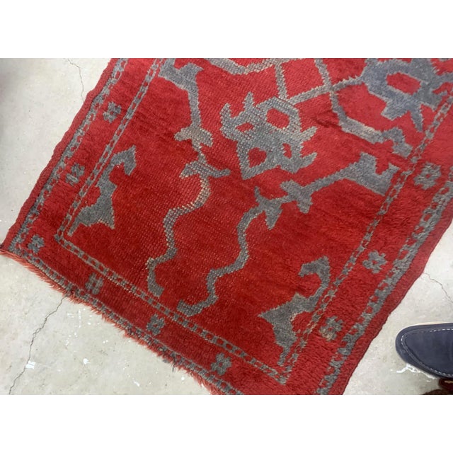Handmade antique Turkish red rug from Oushak region. The rug is from the end of 19th century in original condition, it has...