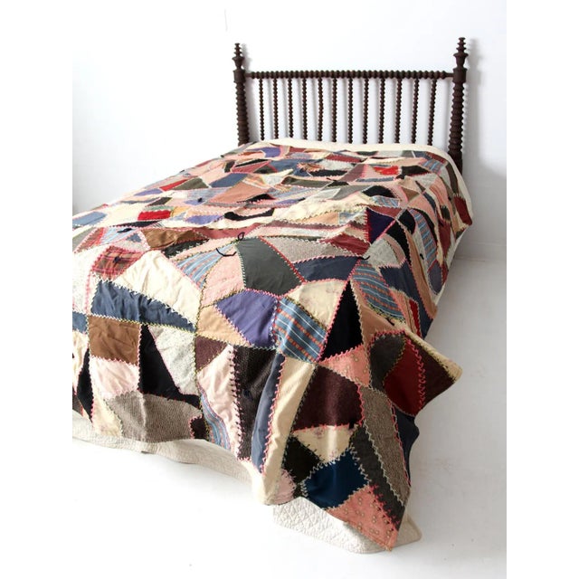 This is an antique mixed textile "crazy" quilt. This style of quilt became in fashion during the late Victorian. The hand-...