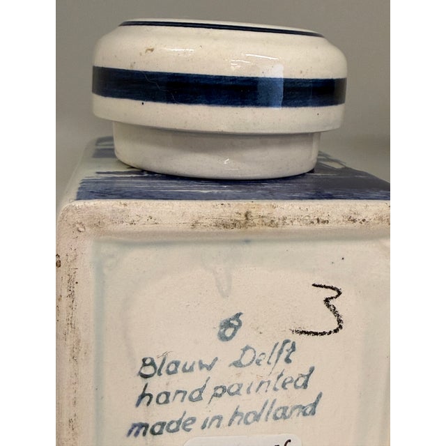A charming vintage hand-painted Delft Blue porcelain jar, beautifully decorated in the classic Dutch tradition with richly...