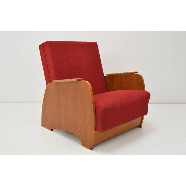 Amrchair that can be converted to a daybed. Made in Czechoslovakia in wood and fabric. The fabric shows signs of use....