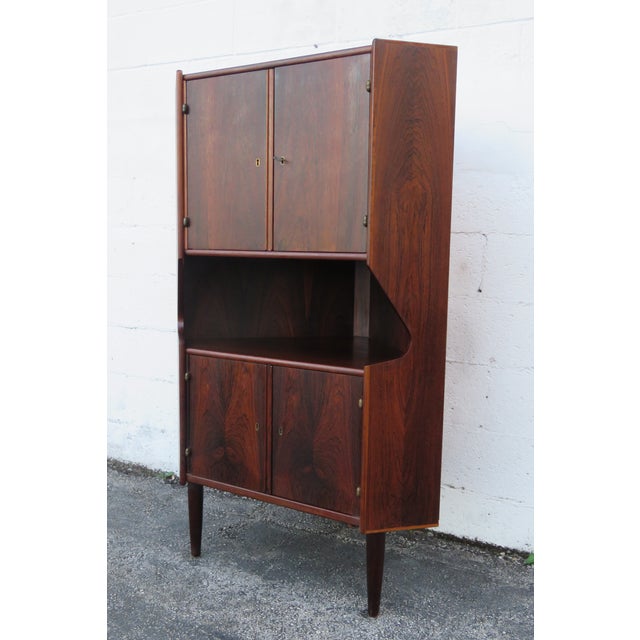 This brilliant Bar is made of wood, rosewood, veneer, and mirror. This Cupboard is an excellent example of Mid-Century...