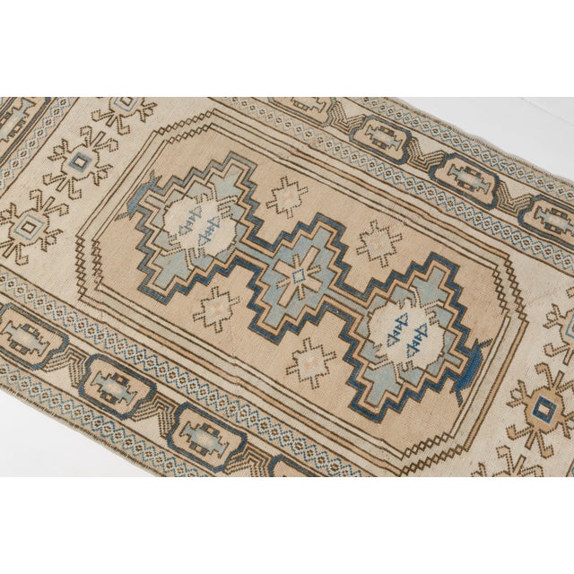 This is a vintage Turkish Oushak rug from the Mid 20th Century. The piece was hand-knotted.