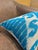 Woven on a traditional loom in pure silk, this lumbar cover carries an ikat pattern in bright sky blue against a white...