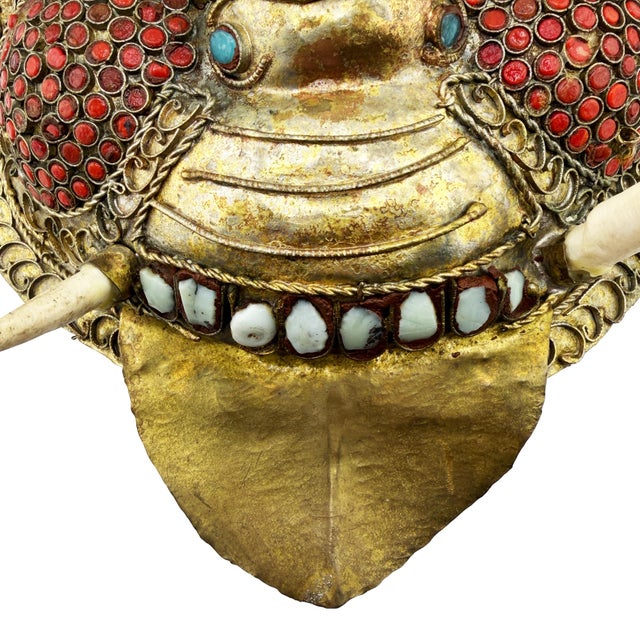 An exceptionally dramatic Himalayan ritual mask, hand-crafted from repoussé gilt copper and lavishly adorned with hundreds...