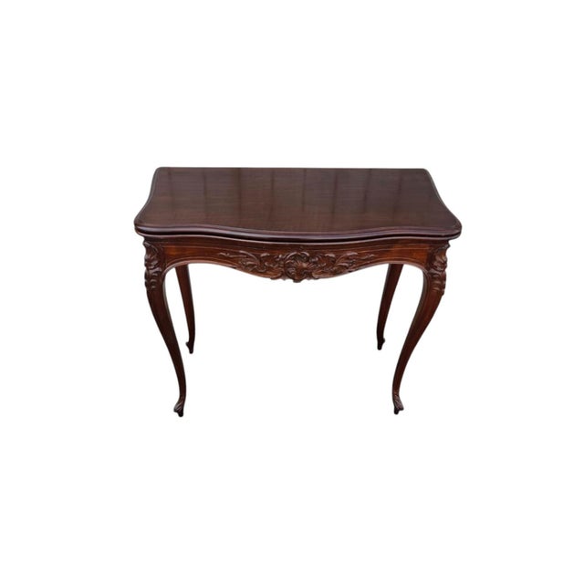 This 19th century French walnut hand carved console table is a stunning piece of furniture that exudes elegance and charm....