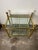 Fantastic vintage two-tier brass and glass side table, often referred to as a bar cart or serving trolley. This specific...