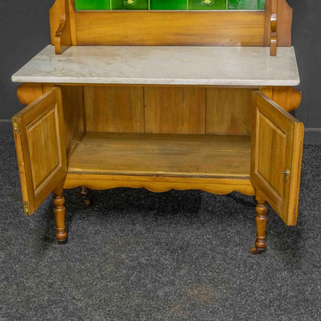 A lovely Victorian birch washstand with a very attractive tiled back. All the external French polish has been re-vitalised...