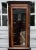 A vintage mahogany English corner display cabinet with divided glass, oval satinwood inlay and banding, and bracket feet....