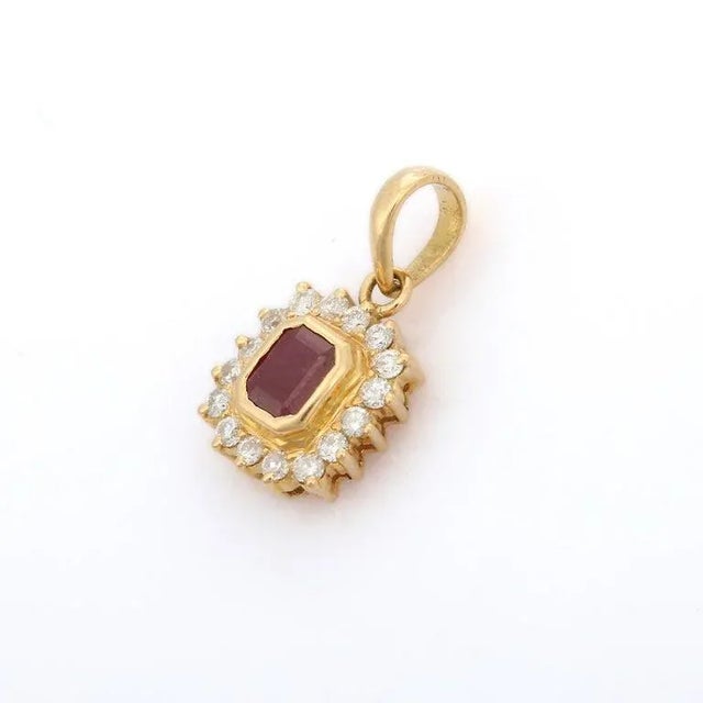 This is part of Chairish’s Fine Jewelry assortment. Natural Ruby Pendant Necklace with Halo of Diamonds in 18K Gold. It...