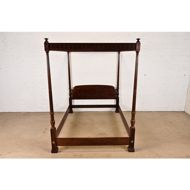 A gorgeous Georgian or Chippendale style four poster queen size canopy bed By Henredon USA, Circa 1980s Carved mahogany,...