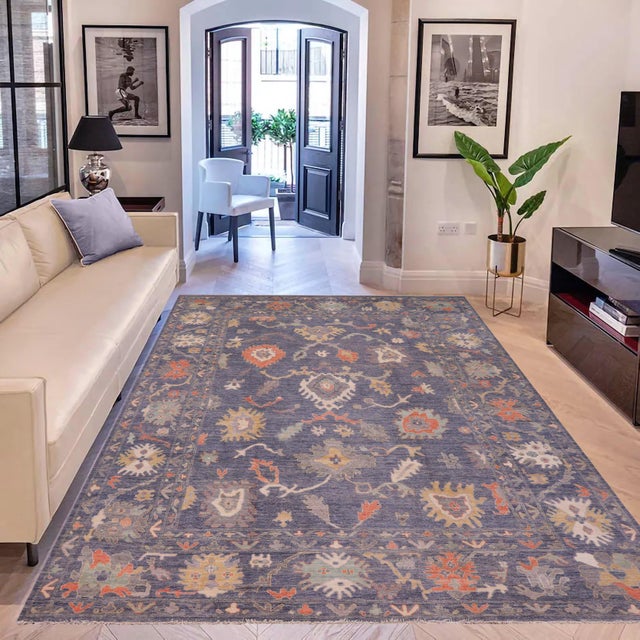 Enhance the ambiance of your home with this magnificent Persian-influenced Turkish hand-knotted rug made by skilled...