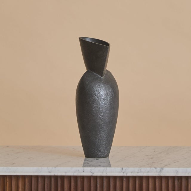 A French ceramic vase by artist André Bloch. Crafted in stoneware and rising in a tapered, elongated silhouette, the...