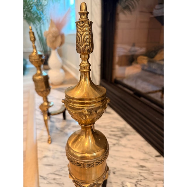Elegant pair of mid-century Japanese brass and wrought iron andirons in the Georgian Revival taste, featuring urn-form...