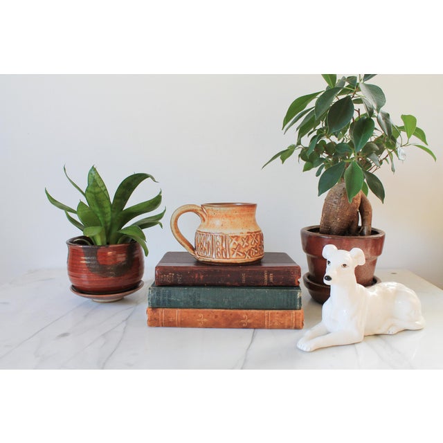 Vintage brown and beige studio art textured pottery mug. Signed by artist on bottom. Minor age wear. No chips or cracks.