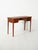 Elegant Scandinavian mahogany desk from the 1940s and 1950s with four drawers and brass handles, featuring a light and...