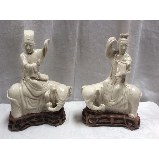 Beautiful antique Chinese Porcelain Blanc de chine figures on elephants. These are on elaborately carved wood bases. Most...