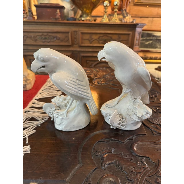 Antique pair is early 19th century Chinese Blanc de Chine porcelain hawks or falcons perched atop rocks both with sea...