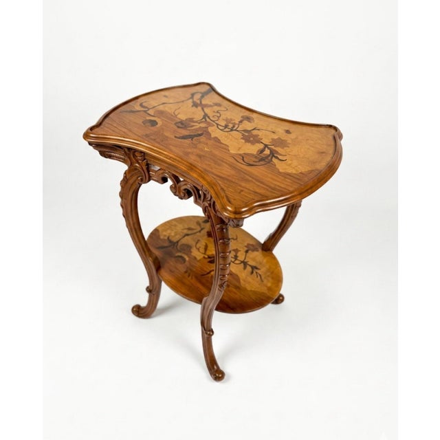 Occasional vintage table in Emile Galle style. Various colored veneers on solid wood. Height: 28.75 in Width: 23.63 in...