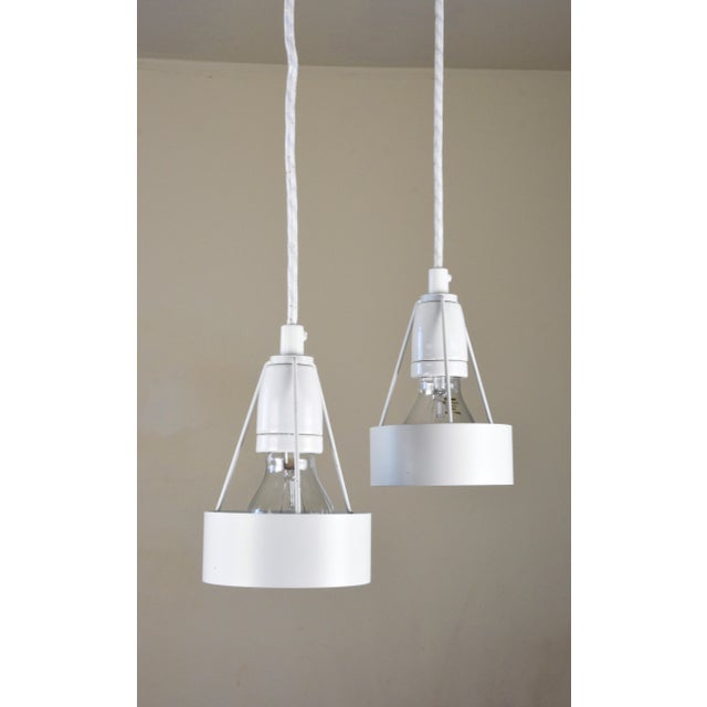 A rare and highly desirable matching pair of early-production pakhus pendant lamps, manufactured by louis poulsen,...
