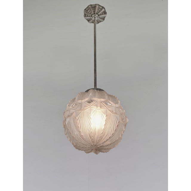 Hettier & Vincent A French 1925-1935 art deco pendant light by Hettier et Vincent in nickel plated bronze. The mounting...
