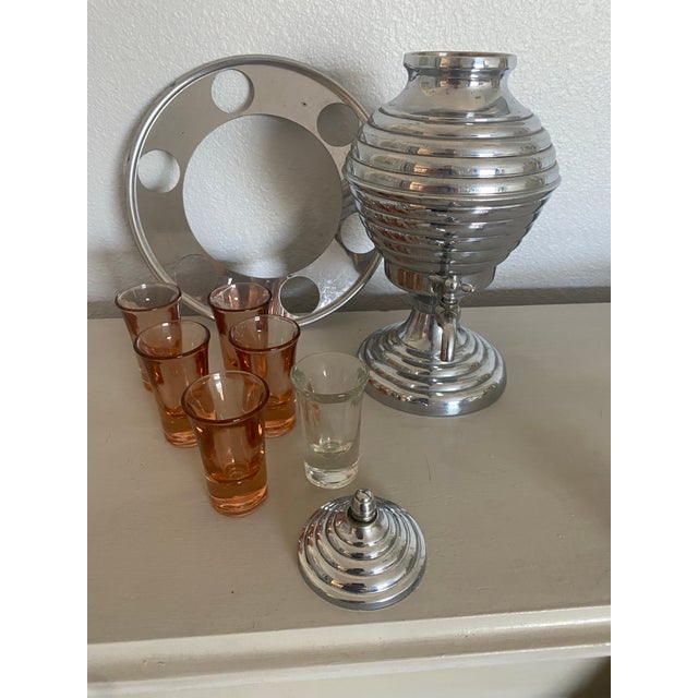 Vintage MCM barware set. Includes liquor dispenser, with working spigot, and six shot glasses. One clear shot glass, five...